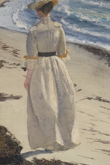She wears a simple white dress, belted in black.