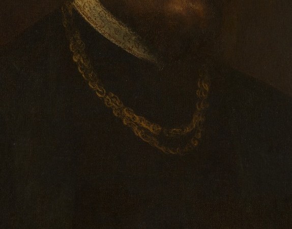 His opulent gold chain also signals his high social standing.