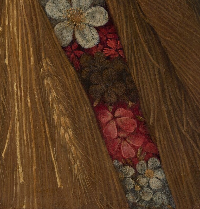 These blooms represent spring or summer, adding a vibrant, floral element to the base.