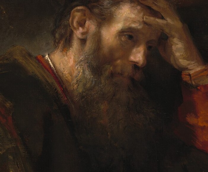 Rendered with loose individual strokes, the beard signals wisdom and age; it also catches secondary reflected light from the open pages below, creating a luminous halo around the chin.