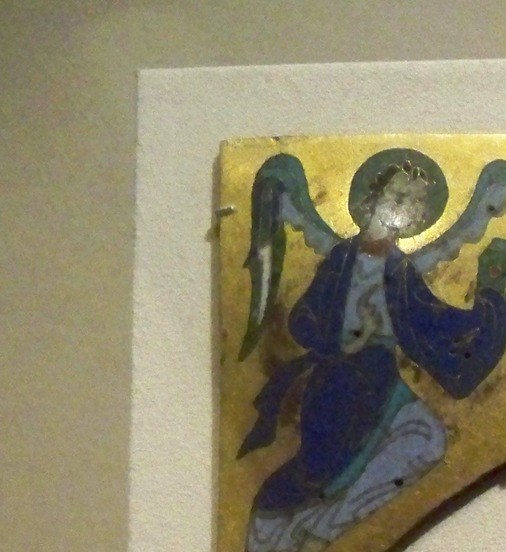 Evangelist tetramorphs surround the Crucifixion to signal all four Gospels witness this event , Matthew's human-winged angel is the most legible of the four