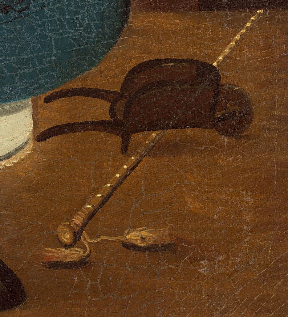 Another hat, fallen on the floor, hints at a moment of transition or pause.