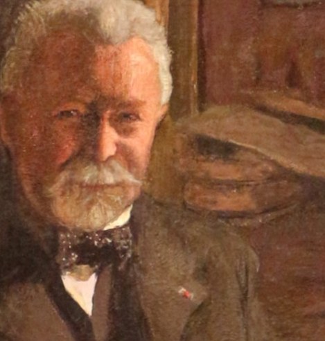 His face shows quiet thought and weariness.