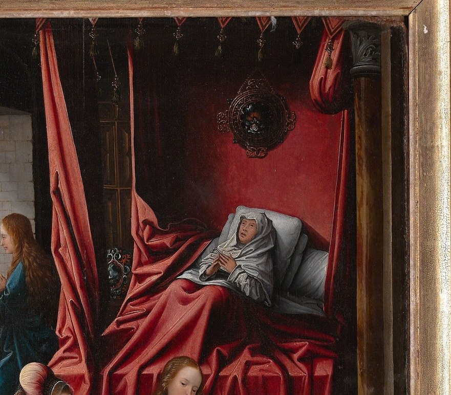 The exhausted mother framed by crimson silk; her posture contrasts with the bustle of attendants and anchors the scene's intimacy.