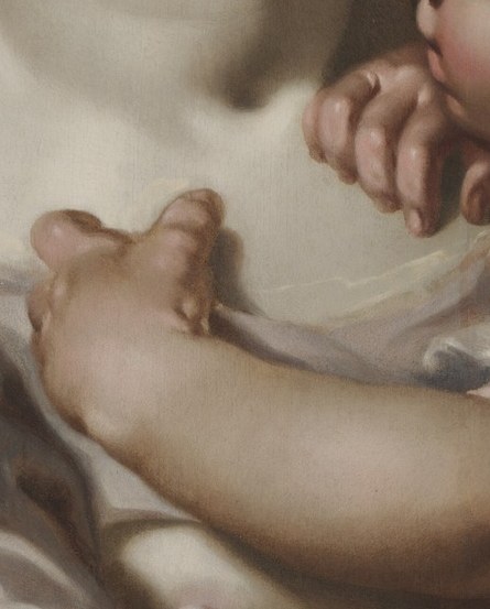 She cradles an infant, symbolizing the innocent, vulnerable in need.