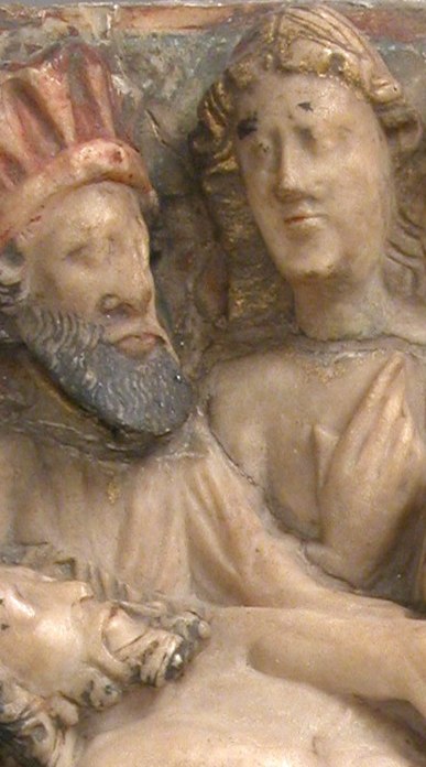 His prominent position and distinctive hat suggest he is a significant figure, perhaps a donor or important witness.