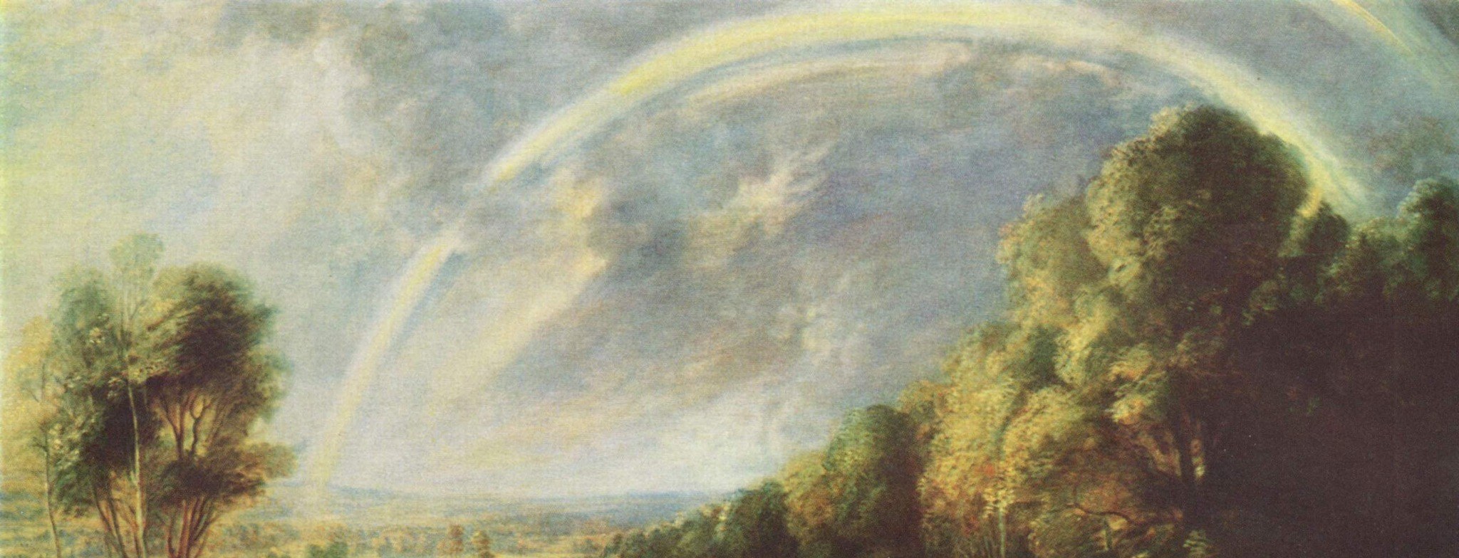 A powerful symbol of hope and divine promise, its vivid colors contrast with the muted sky.