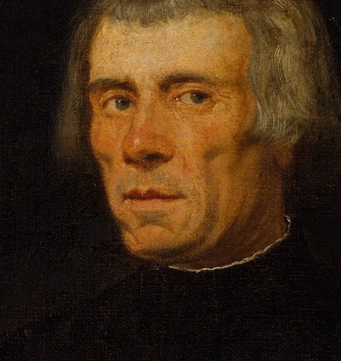 His gaze is direct and intense, conveying a sense of introspection and gravitas.