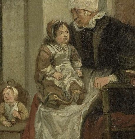 A woman cradles a baby by the fire's warm glow.