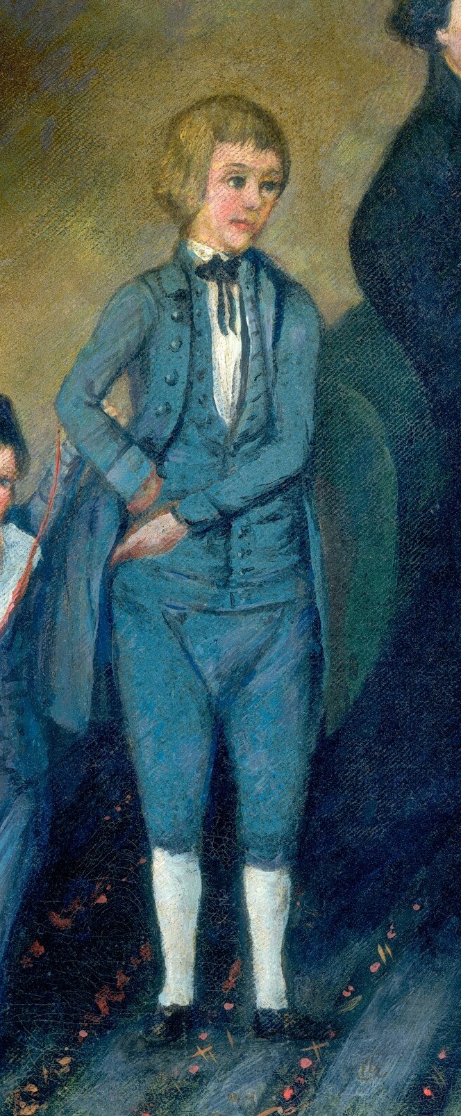 His formal attire and stance indicate his position as a young gentleman of the household.