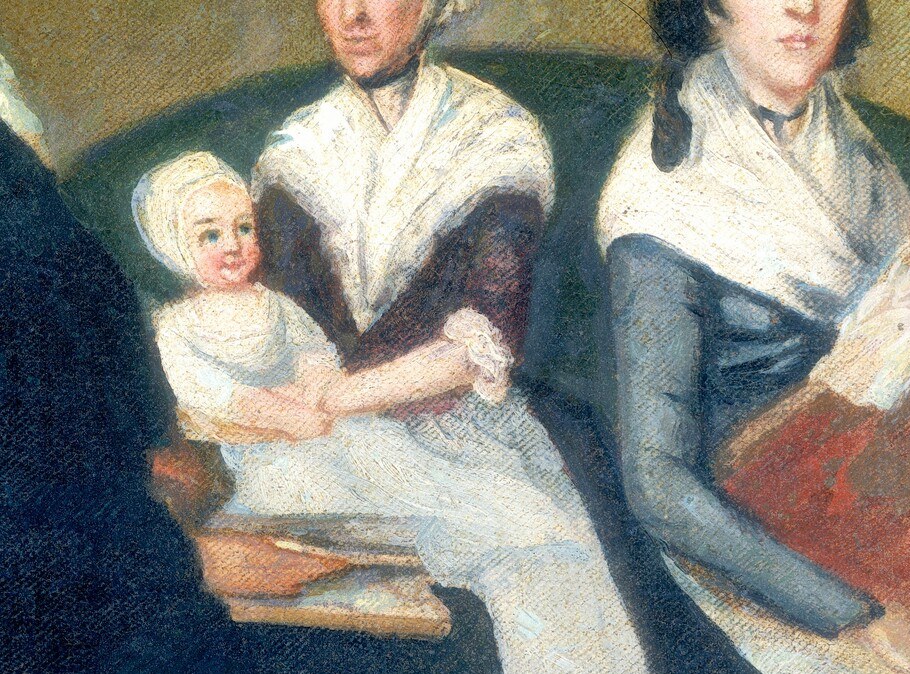 She cradles the infant, symbolizing new life and vulnerability.
