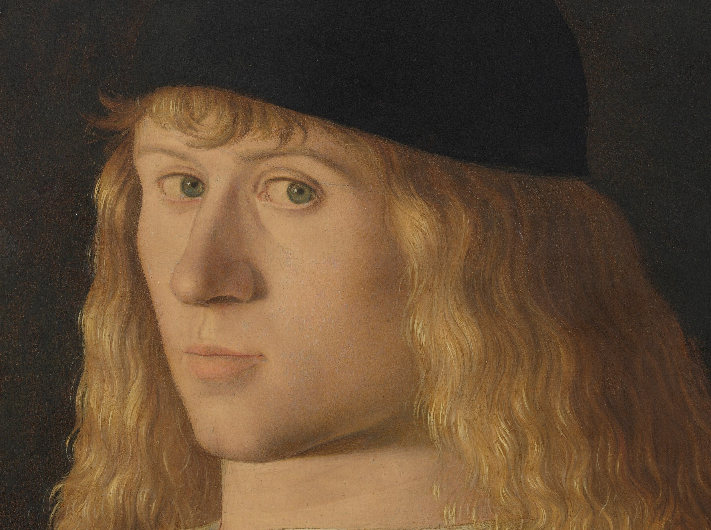 Loose, flowing hair marks him as a youth, under thirty.