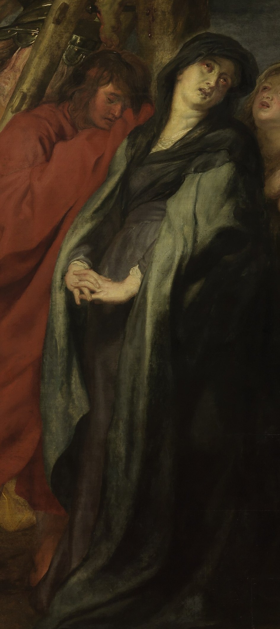 Her grief-stricken posture and covered face suggest profound sorrow and mourning.