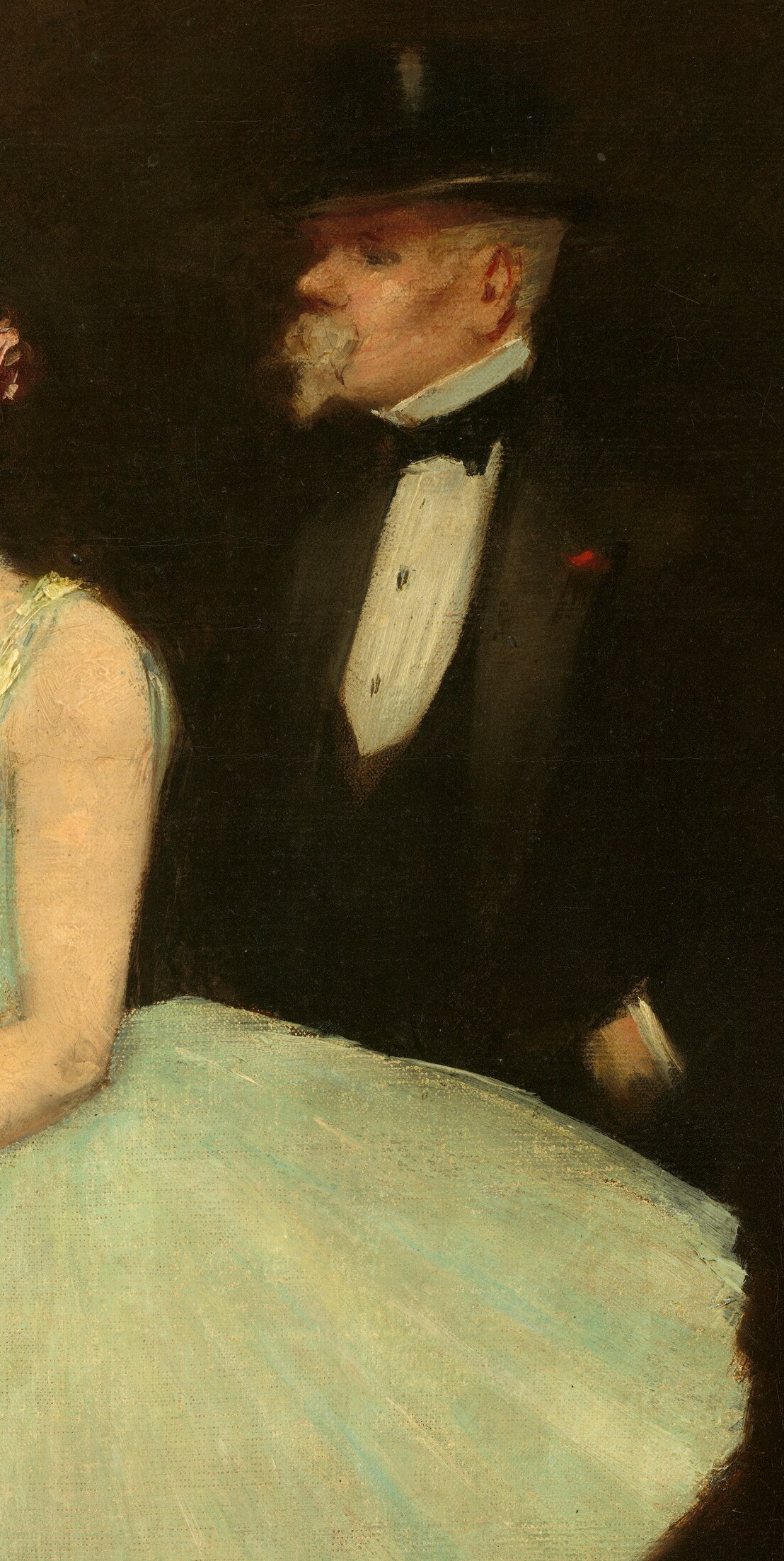 Behind her, a man in a dark suit watches from the shadows.