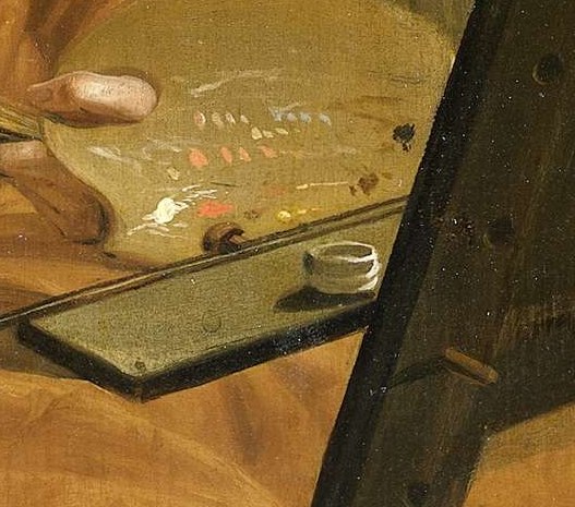 Dotted with colorful pigments, the palette is a direct symbol of his craft and the raw materials of his art.
