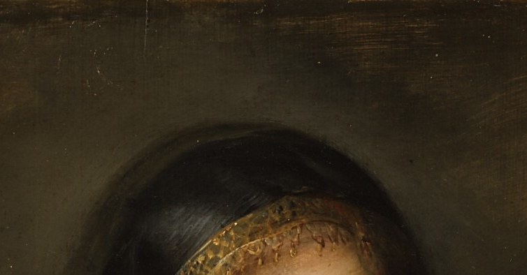 Under the black hat, a hidden luxury: a gold lace cap glows.