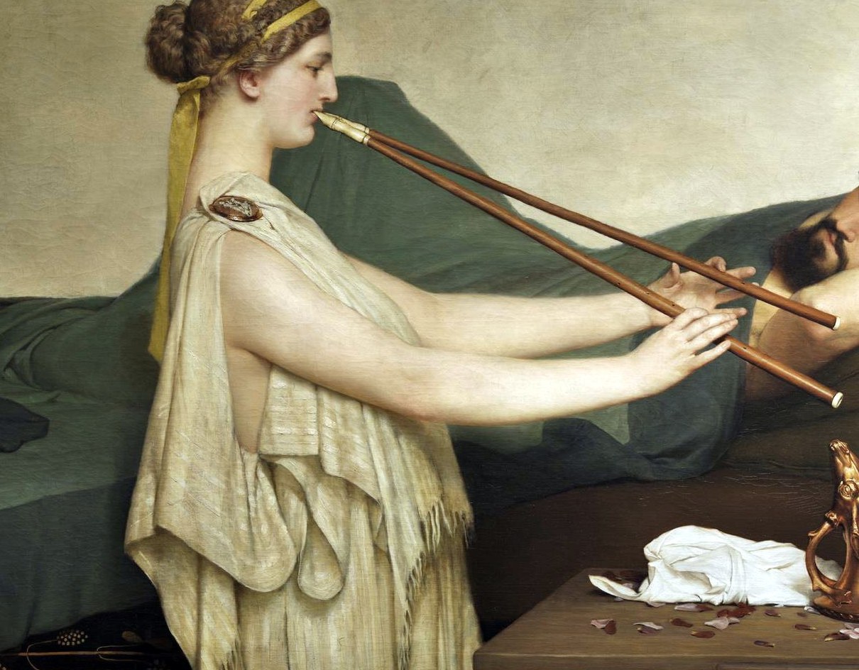A woman plays a flute, lost in the music.