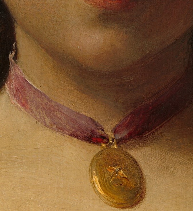 She wears a locket, hinting at a private, untold story.