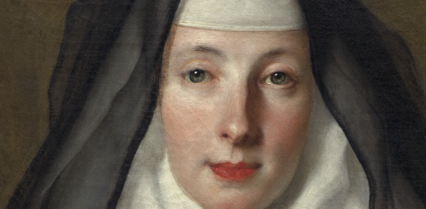 Her steady eyes hold the room. She knows who she is.