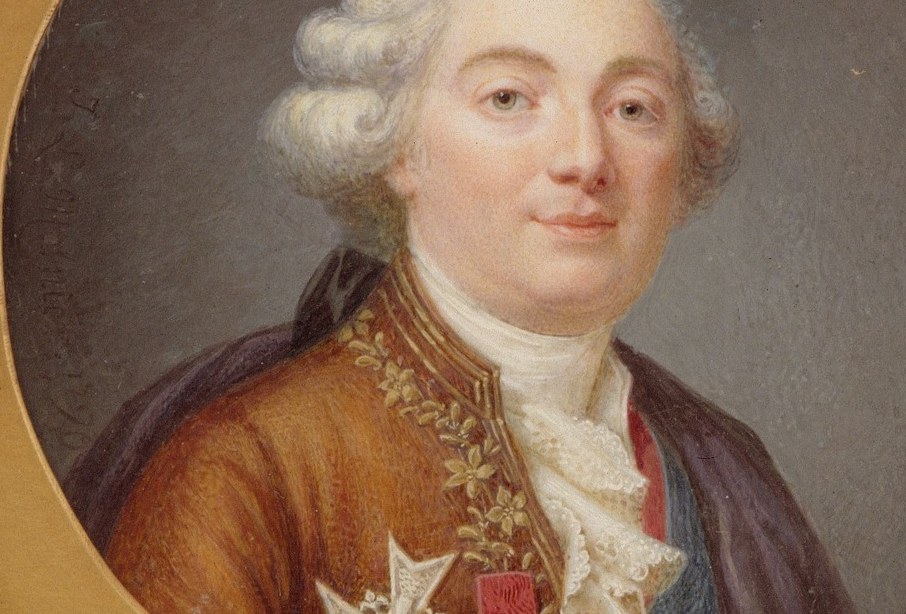 He wears the blue sash of France's highest order.