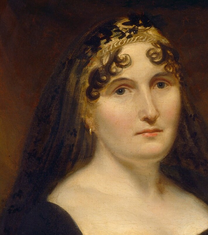 Her direct gaze conveys a sense of calm authority and maternal presence.