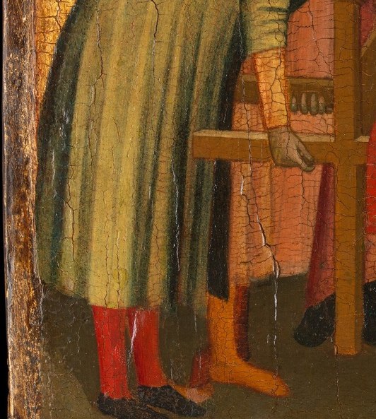 A figure hunched beyond the frame of the drama.