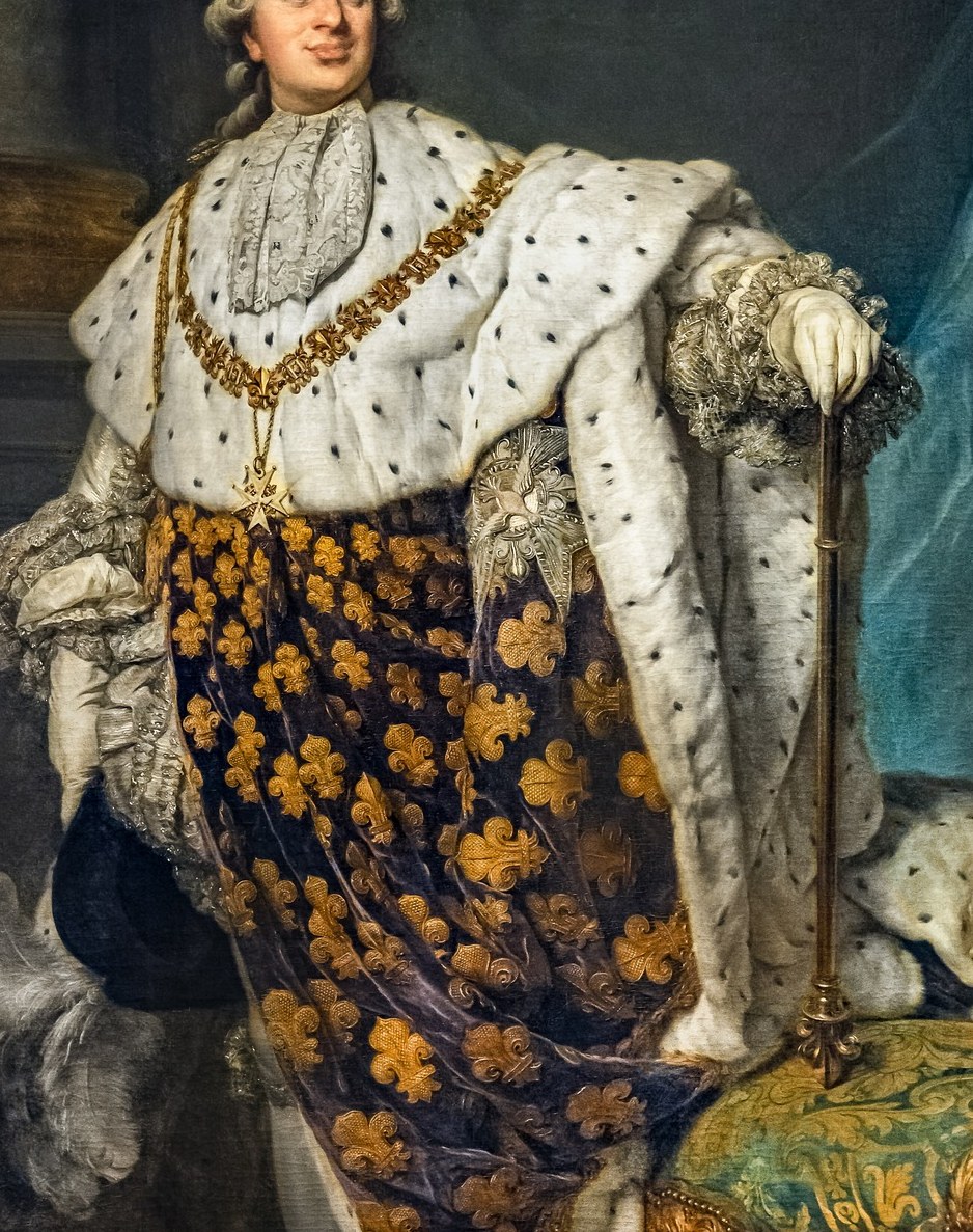 He is wearing the opulent robes from his coronation.