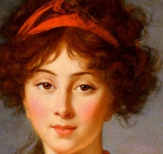 A red headband holds her curly hair.