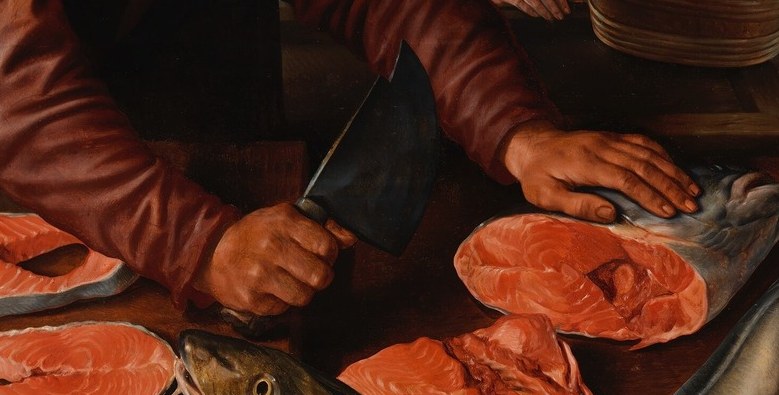 A bearded seller's hands work a fish, practiced and sure.