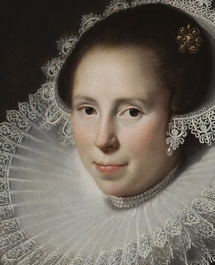 Her direct gaze and subtle smile convey a sense of calm confidence and social poise.