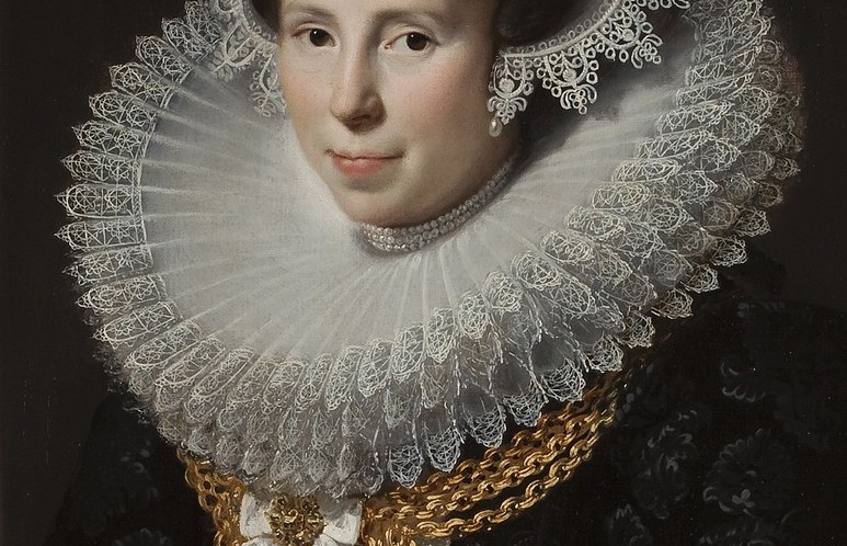Notice her elaborate lace collar and heavy gold chain.