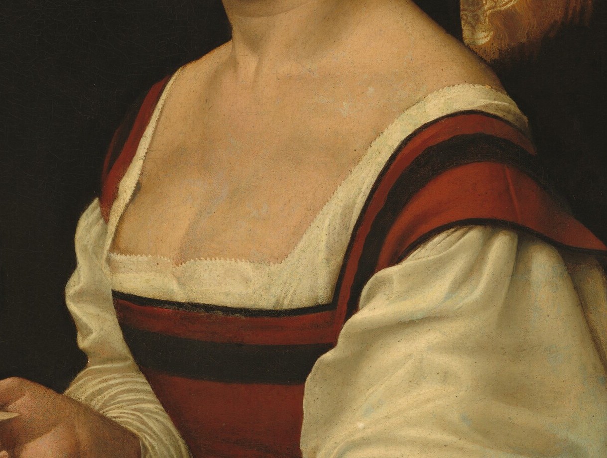 The saturated red signals wealth; the precise rendering of the woven border trim along the left seam is a material record of Florentine textile craft.