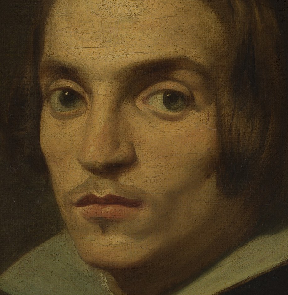 His wide, dark eyes hold a quiet, contemplative gaze.