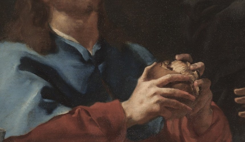 A traveler breaks bread at an inn.