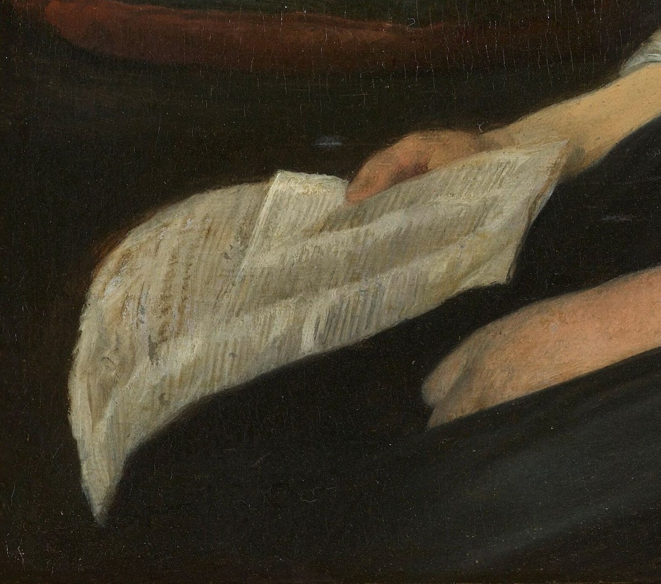 She delicately holds a piece of folded paper, perhaps a letter.