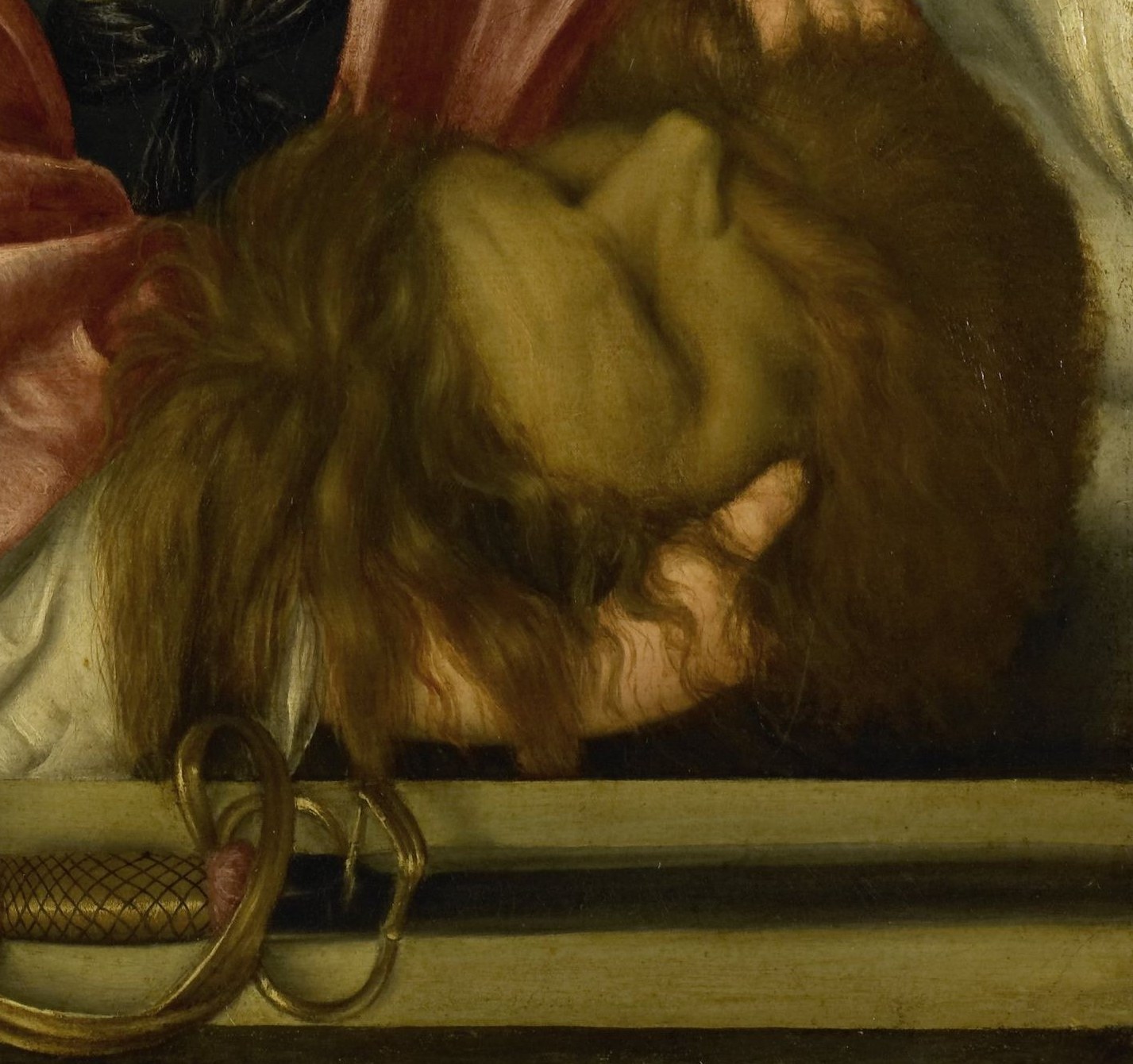 The gruesome detail of the head, wrapped in cloth, is a stark symbol of Judith's victory and the narrative's climax.