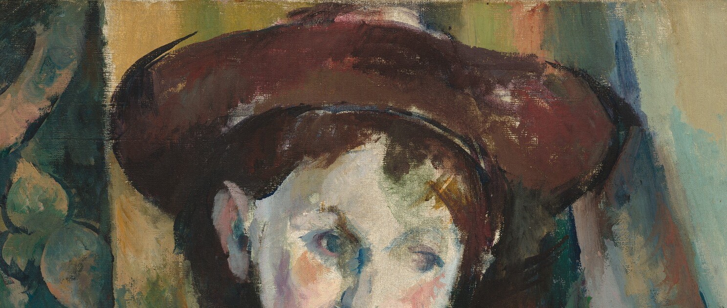 The hat echoes the waistcoat's red and frames the boy's face; its slight tilt adds a subtle sense of personality and informality.
