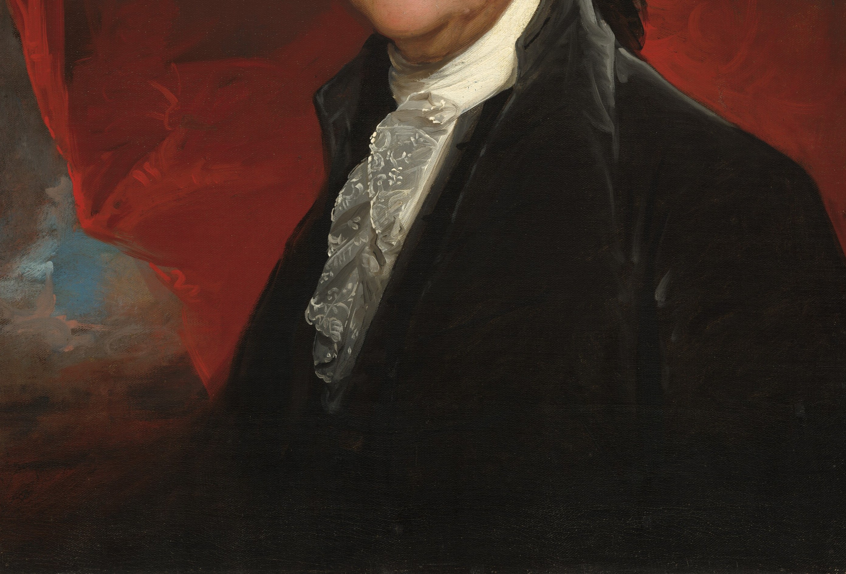 Formal coat absorbs light, framing the face.