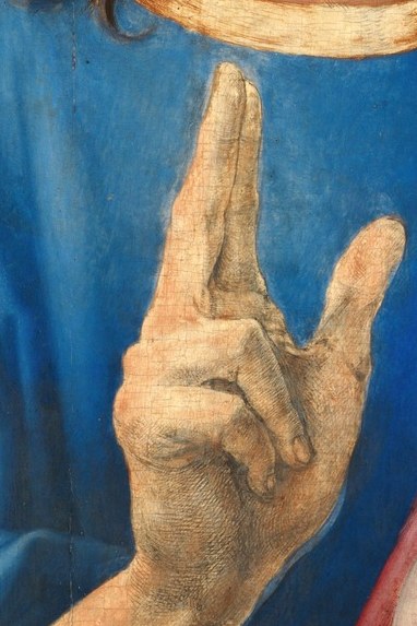 His raised hand offers a blessing to the viewer.
