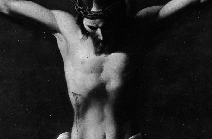 The body pushes forward from total darkness.