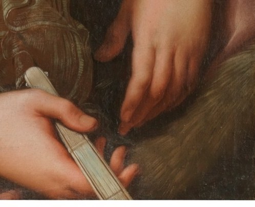 But look at her hands, holding a simple folded fan.
