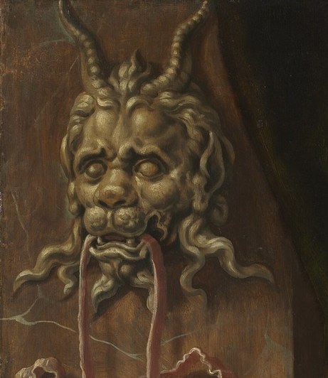A grotesque demon head is in the background.