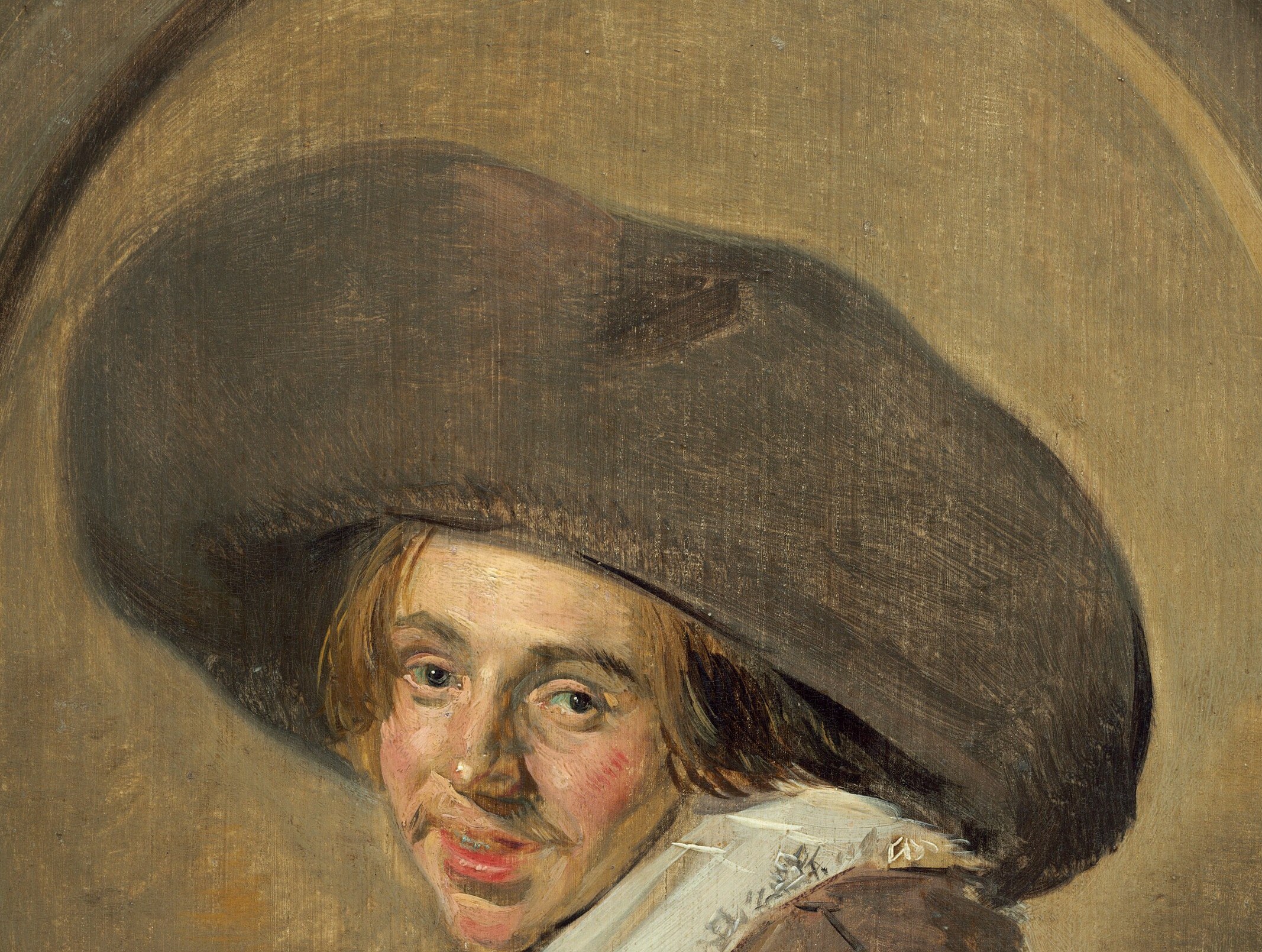The dramatic shadow cast by the hat obscures part of his face, adding an element of mystery and emphasizing his features.