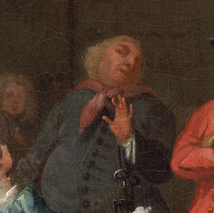 This man reacts dramatically, his mouth open in surprise or delight.