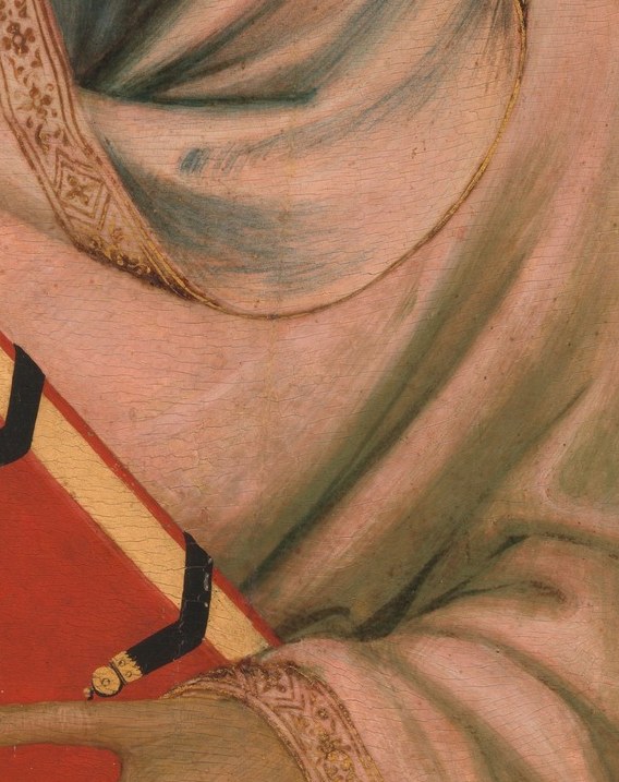 A red book, offered forward. This is the first clue.