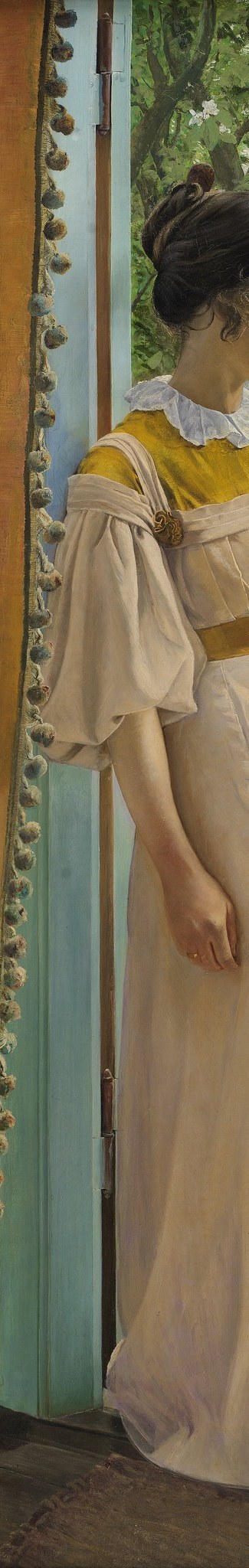 She stands in a garden doorway, poised between indoors and out.