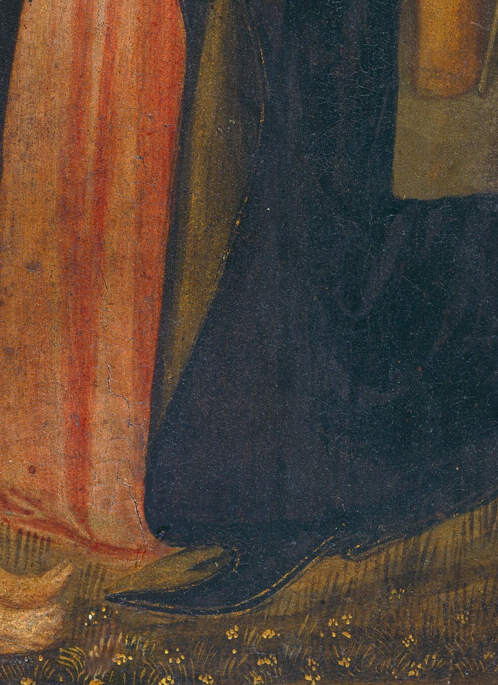 The Christ child, glowing, lies vulnerably on the ground.