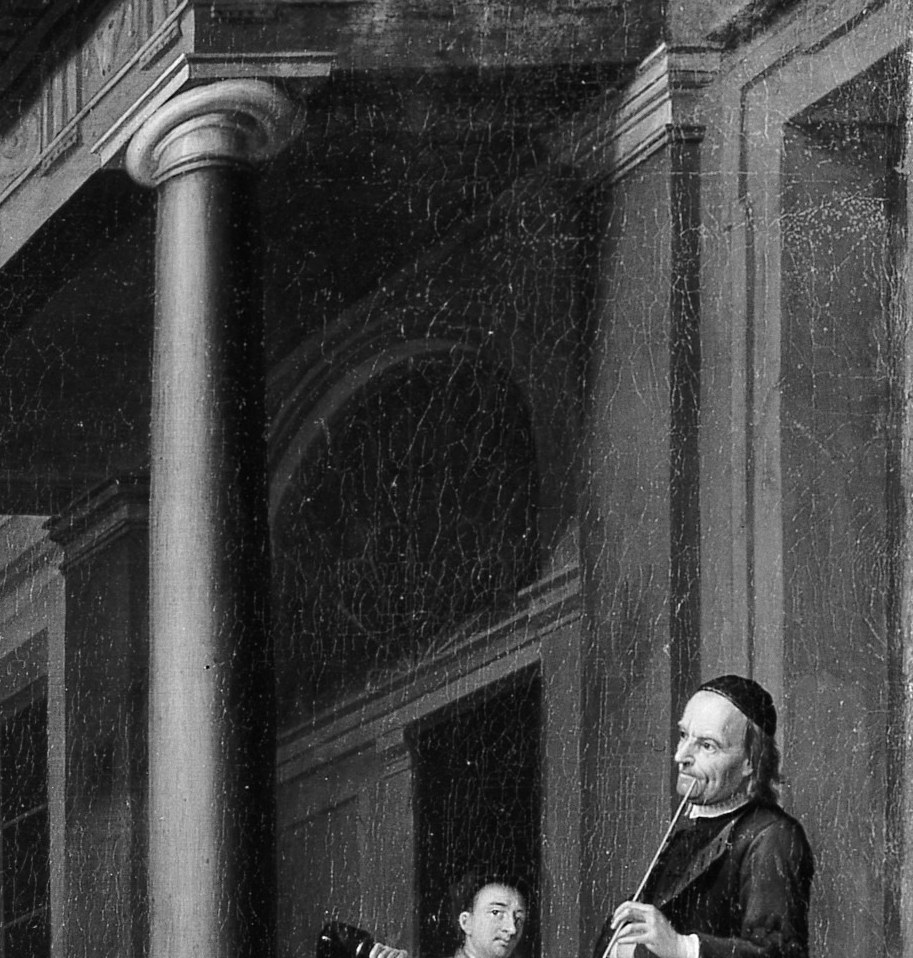 Above them, another audience watches from the balcony.