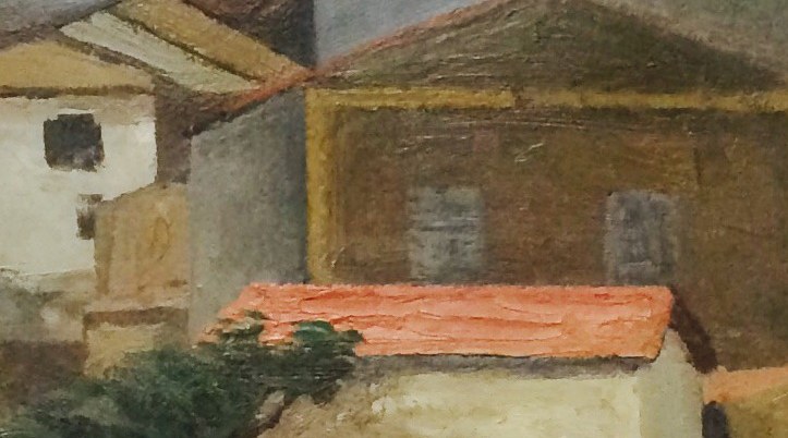 The terracotta roof and white rendered walls glow against the grey hills.