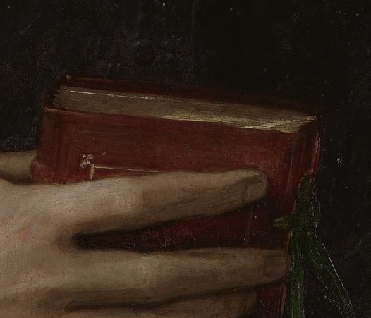 The gentle clasping of the book conveys a sense of quiet contemplation and possession.